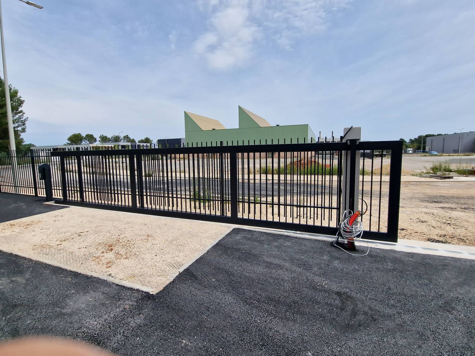 Installation d'une motorisation sur un portail coulissant industriel à Bouc Bel Air pour une entreprise de menuiserie.